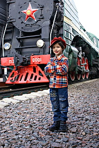 boy standing beside train thumbnail
