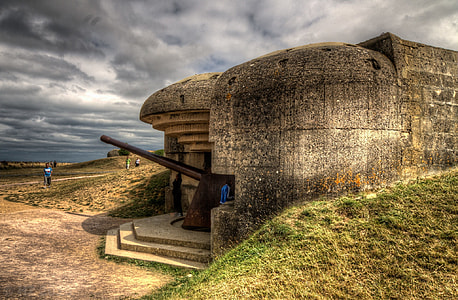person standing in door of stone building thumbnail