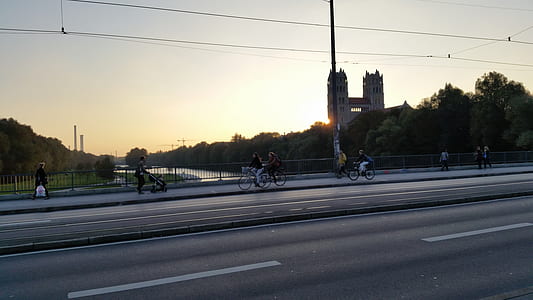people riding on bikes near metal fence thumbnail
