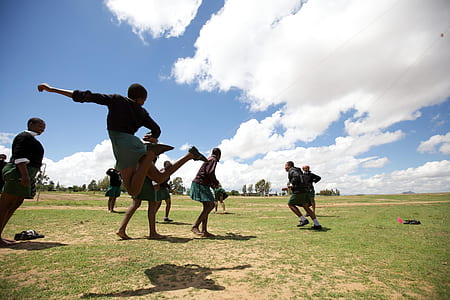people playing on green field thumbnail