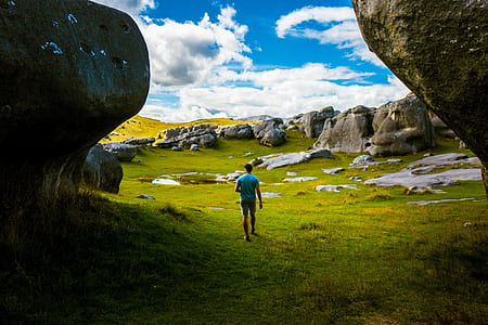 man between huge rock formations thumbnail