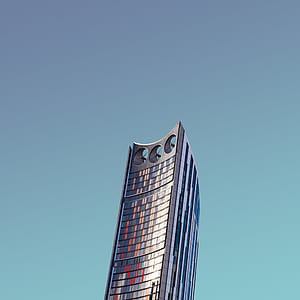 low-angle photography of gray concrete building under clear sky thumbnail