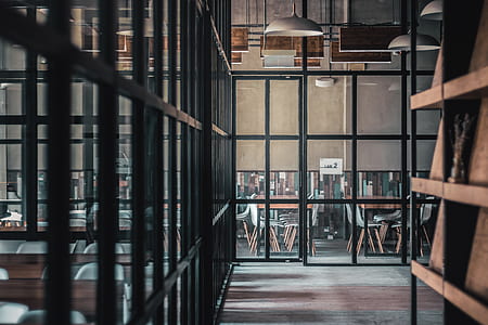black metal framed glass door near brown table and chairs thumbnail
