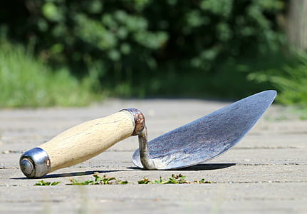 close-up photo of brown wooden hand tool on floor thumbnail