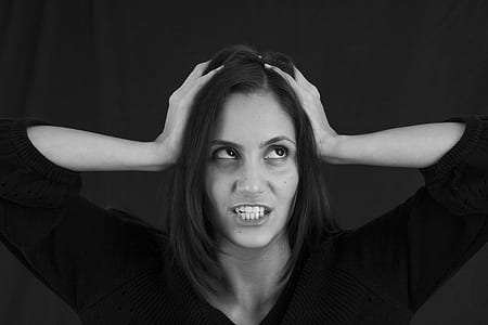 photo of woman holding her head thumbnail