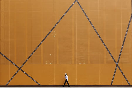 Man Walking By Orange Photo thumbnail