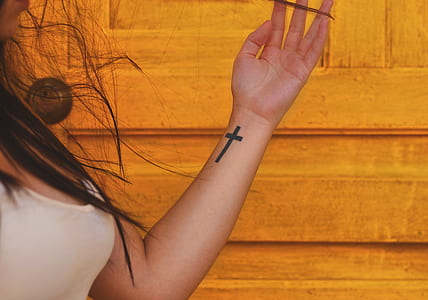 woman with cross tattoo thumbnail