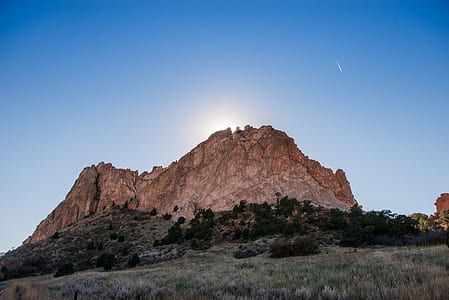 brown mountain surrounded by trees during daytime thumbnail