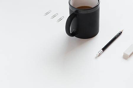 black coffee mug beside pencil thumbnail