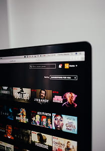turned on flat screen television near white painted wall thumbnail