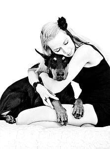 woman hugging adult Doberman pinscher thumbnail