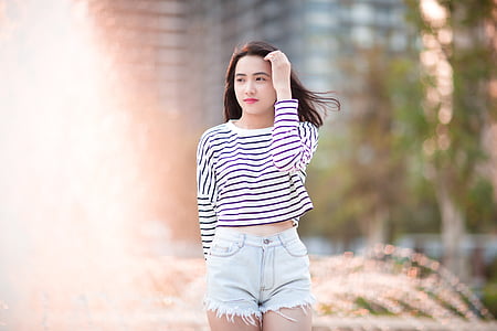 woman wearing blue denim short shorts thumbnail