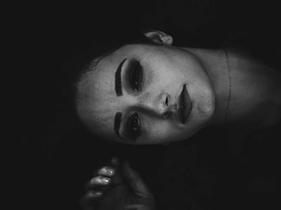 woman holding her head in grayscale photography thumbnail