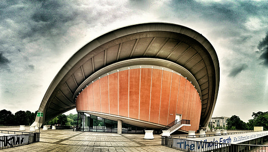 brown and gray building under gray clouds thumbnail