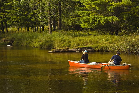 man and woman riding canoe boat thumbnail
