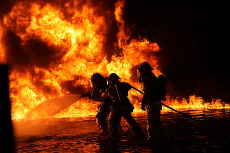silhouette of three firefighters surrounded by fire thumbnail