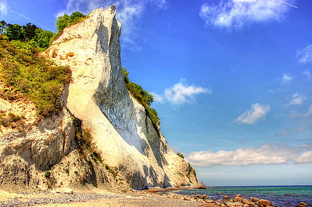 clear sky over rock cliff during daytime thumbnail