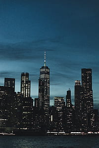 concrete building near ocean at nighttime thumbnail