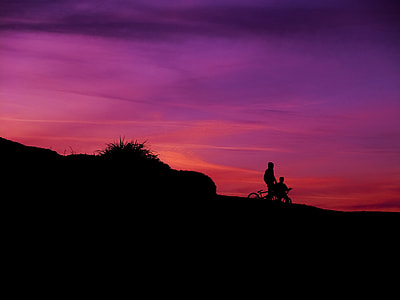 silhouette of two person riding bicycle during golden hour thumbnail