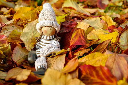 female wearing white coat doll on leaves thumbnail