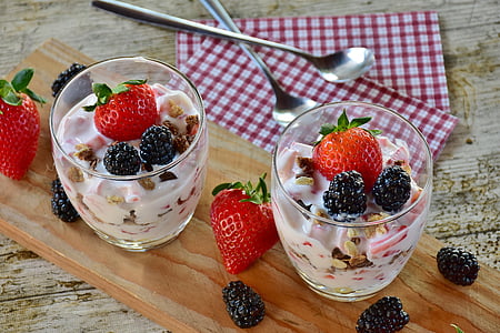 two fruit salad in clear glasses near two spoons thumbnail
