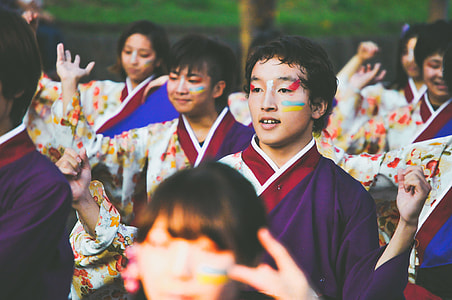 man wearing traditional Oriental robe raising hands during daytime thumbnail