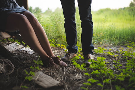 man wearing brown tassel shoes beside woman in brown sneakers near green grass open field thumbnail