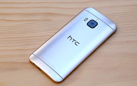 silver HTC Desire One M9 on brown surface thumbnail