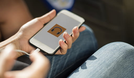 person holding turned on white iPhone 5 thumbnail