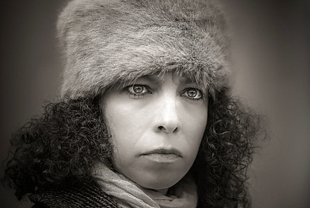 long curly hair woman wearing fur hat thumbnail