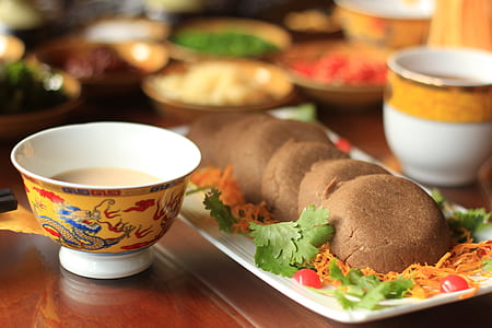selective focus photography of bowl near tray of pastries thumbnail