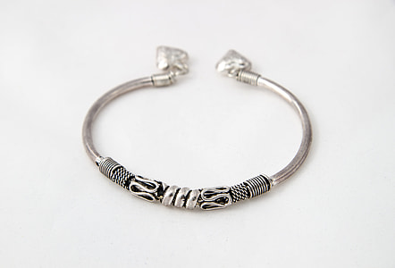 silver-colored snake-sculpted bracelet on white surface thumbnail