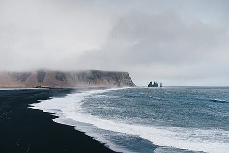 body of water near cliff thumbnail