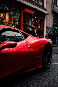 selective focus photography of red Ferrari coupe park near sidewalk during daytime thumbnail