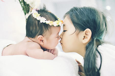 photo of girl kissing a baby thumbnail