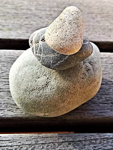 cairn on brown wood plank thumbnail