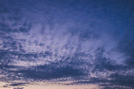 low-angle photo of scattered thick gray clouds during golden hour thumbnail