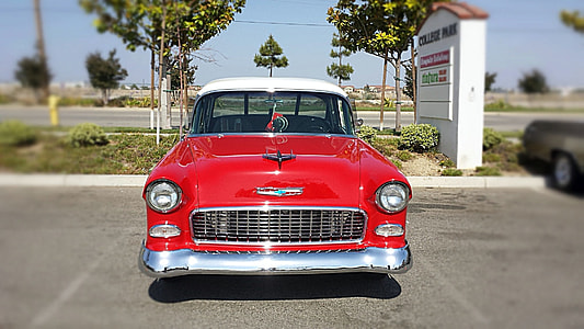 red car parked near green leafed tree thumbnail