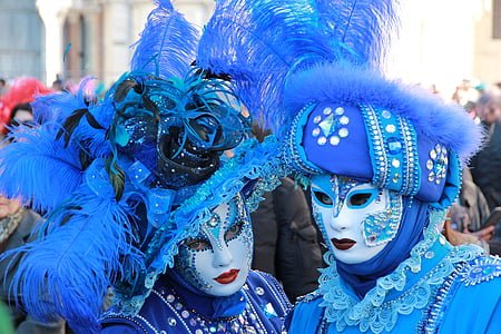 person gathered on street wearing masquerade masks thumbnail