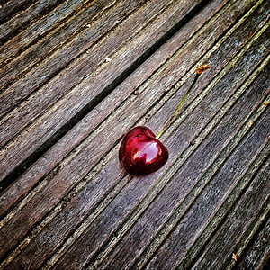 red cherry on black and brown surface thumbnail