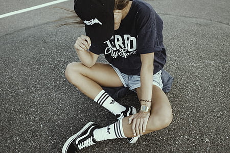 woman sitting on gray concrete pavement thumbnail