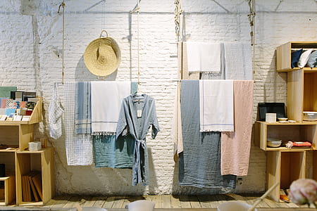 assorted-color towels and scarves hanging on clothes string thumbnail