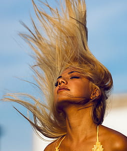 woman wearing yellow floral bikini top looking at the sky during daytime thumbnail