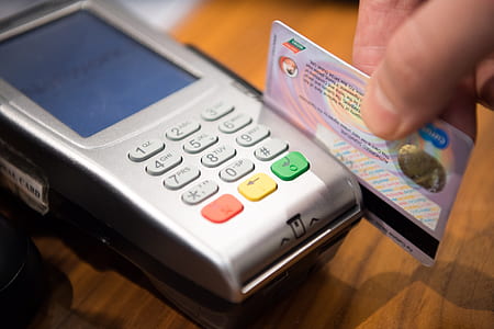 person swiping card on payment terminal thumbnail