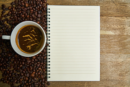 coffee mug on table near notebook thumbnail