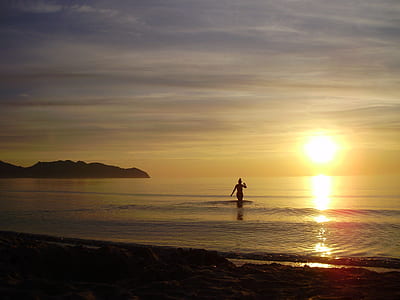 person walking in water over golden hour thumbnail