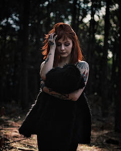 Photography of a Woman Holding Black Fur Coat thumbnail