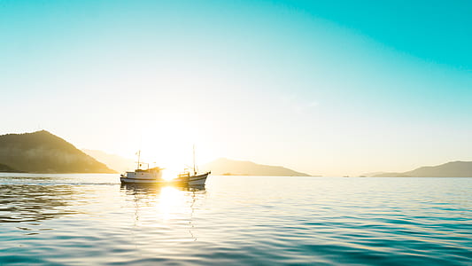 boat on sea near mountain thumbnail