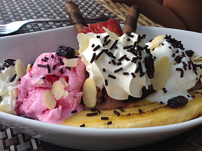 sliced banana top with strawberry and vanilla ice cream drizzled with nuts and chocolate sprinkles thumbnail