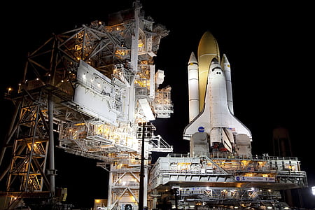 white and yellow space shuttle during nighttime thumbnail